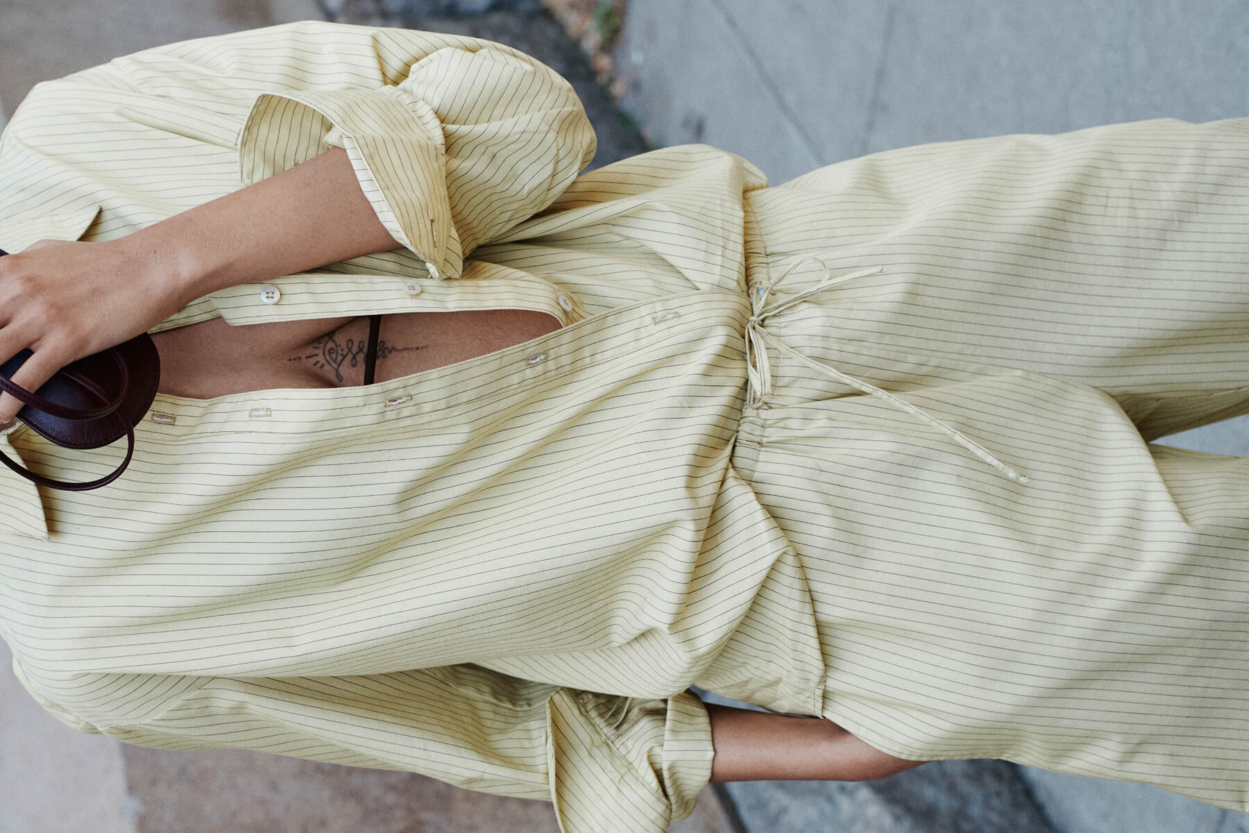 Close up of striped button down and matching pant.