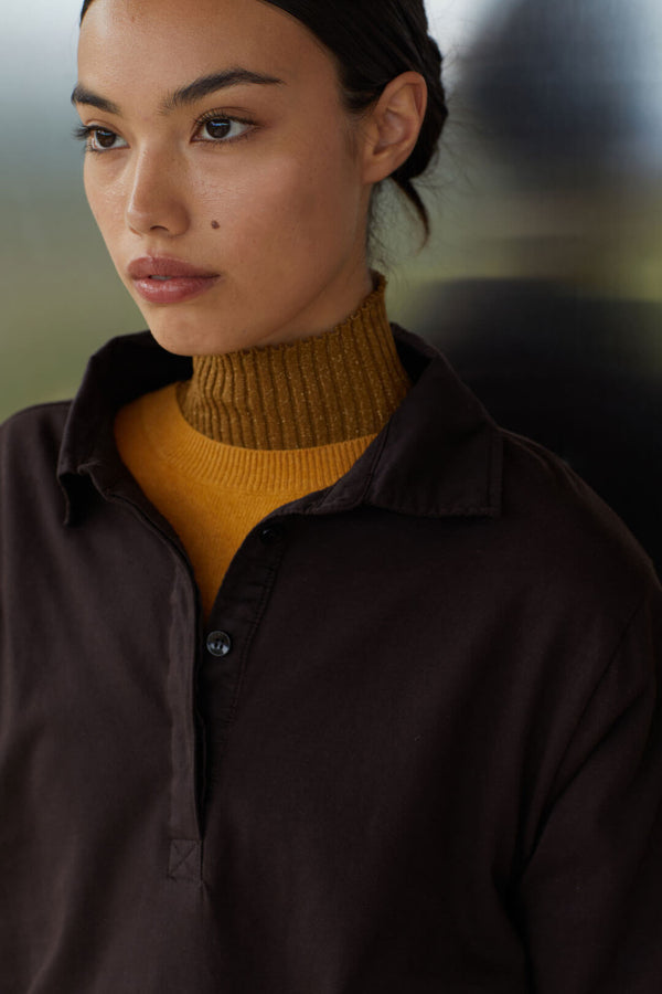 Close up of woman in layered turtleneck, zoe mustard sweater and choco Margo polo