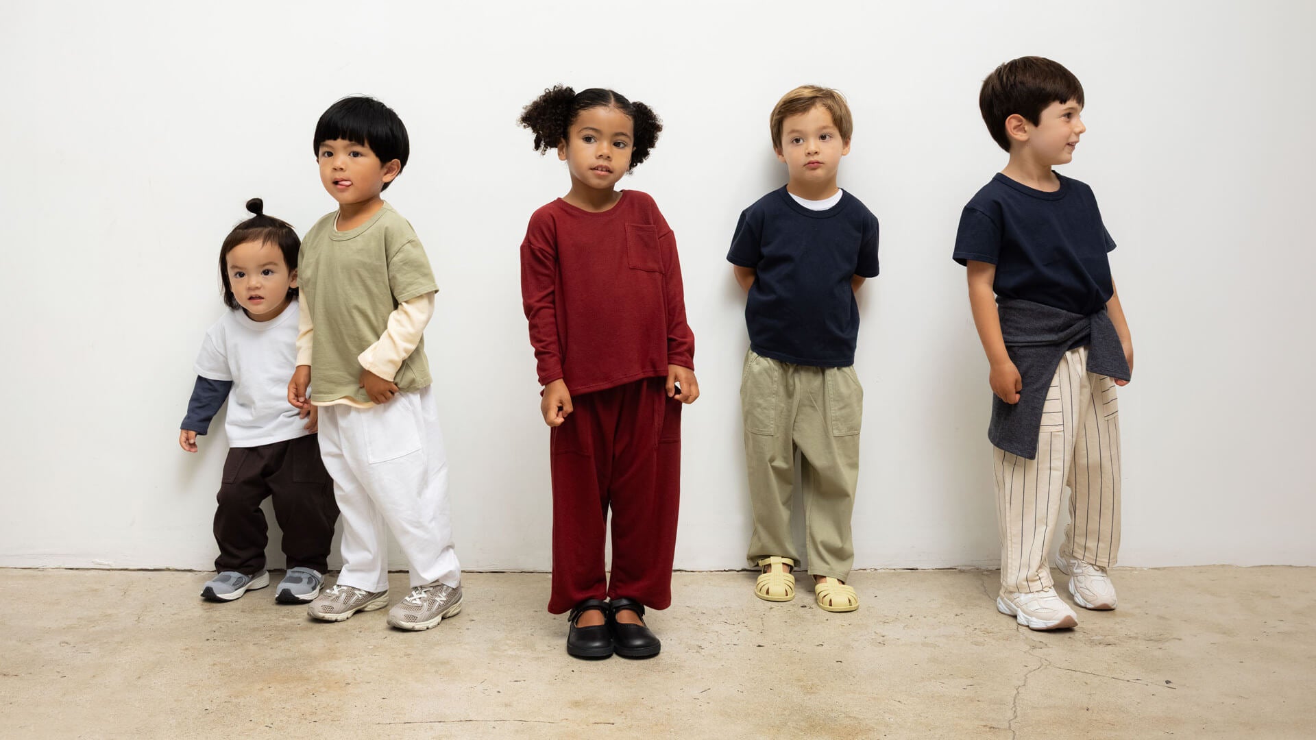 Kids in LESET Bebe Sets standing against wall together