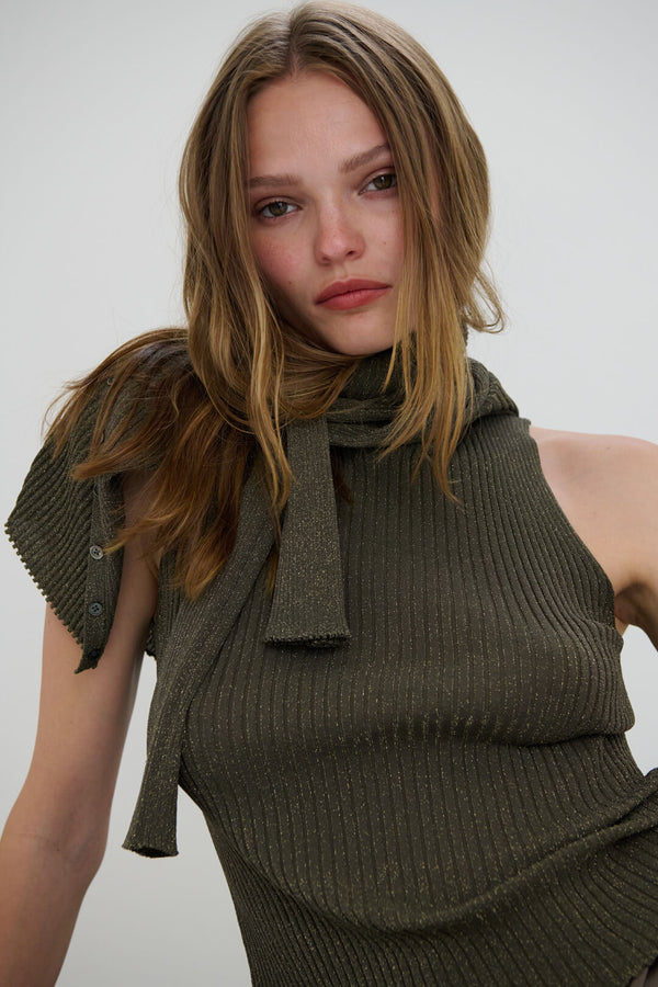 Close up of Woman wearing Blake Moss sweater draped over sleeveless mock.