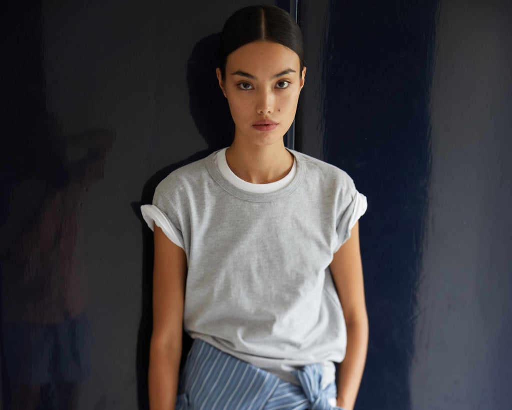 Woman in grey Margo T-shirt layered over white Tee