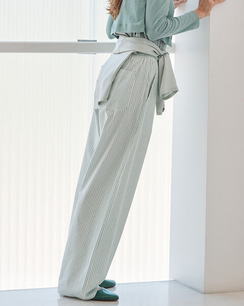 Woman standing in white Pointelle baby tee and Barb slip skirt.