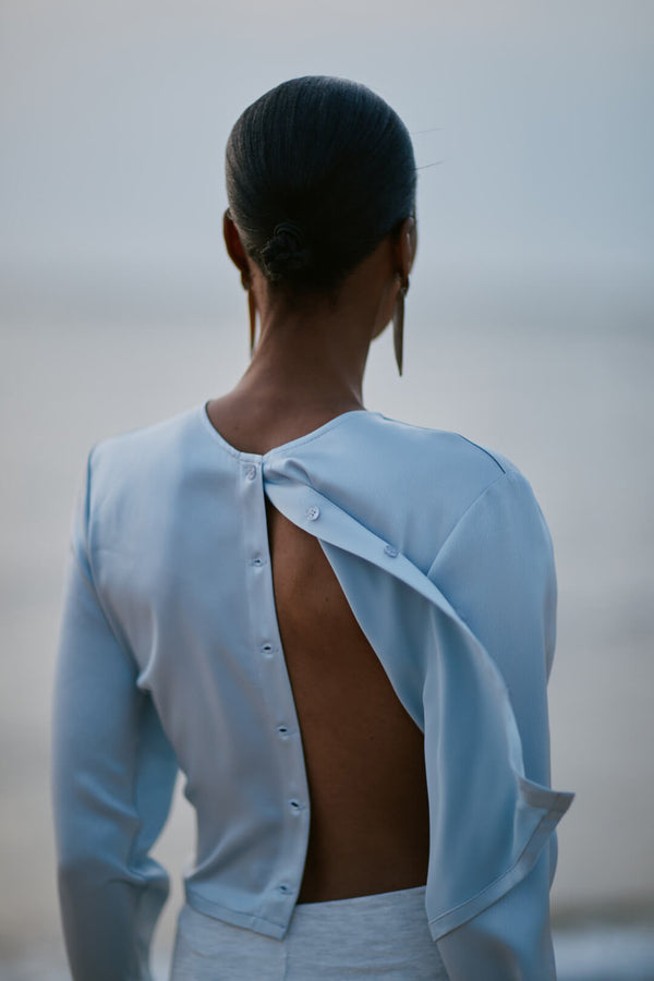 Back of woman in unbuttoned powder Barb Cardigan