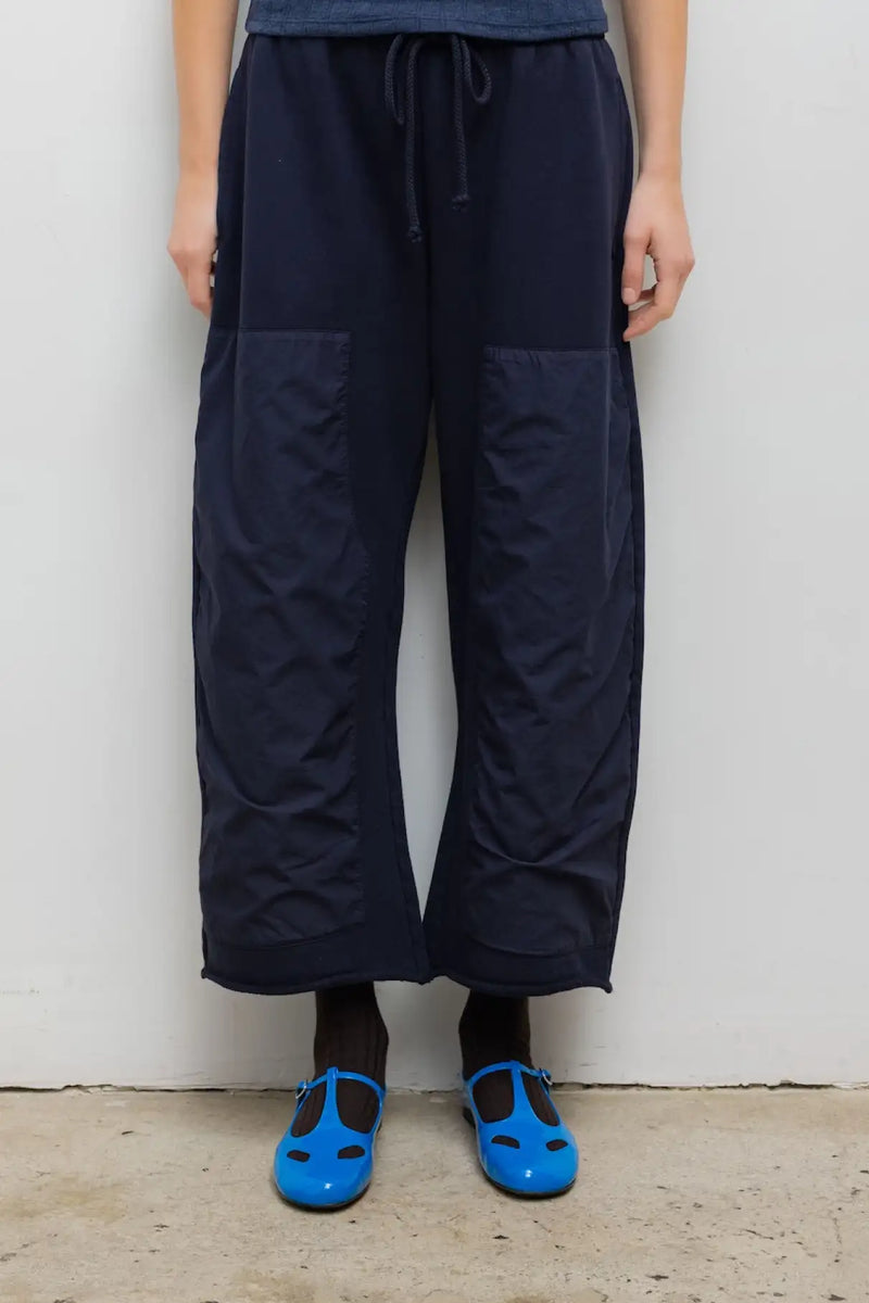 Close up of model wearing the Jamie carpenter pant in navy.