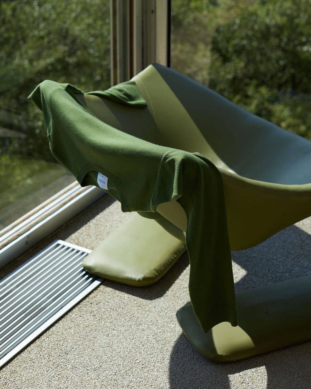 Green Sweater draped over a green chair