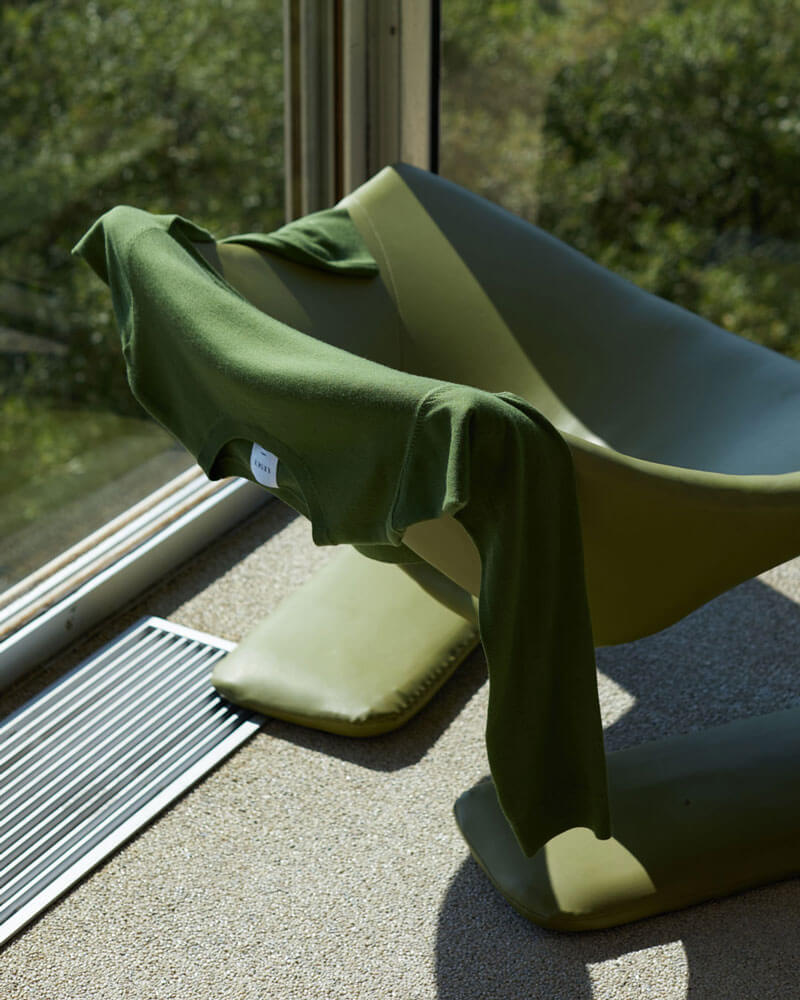 Green Sweater draped over green chair