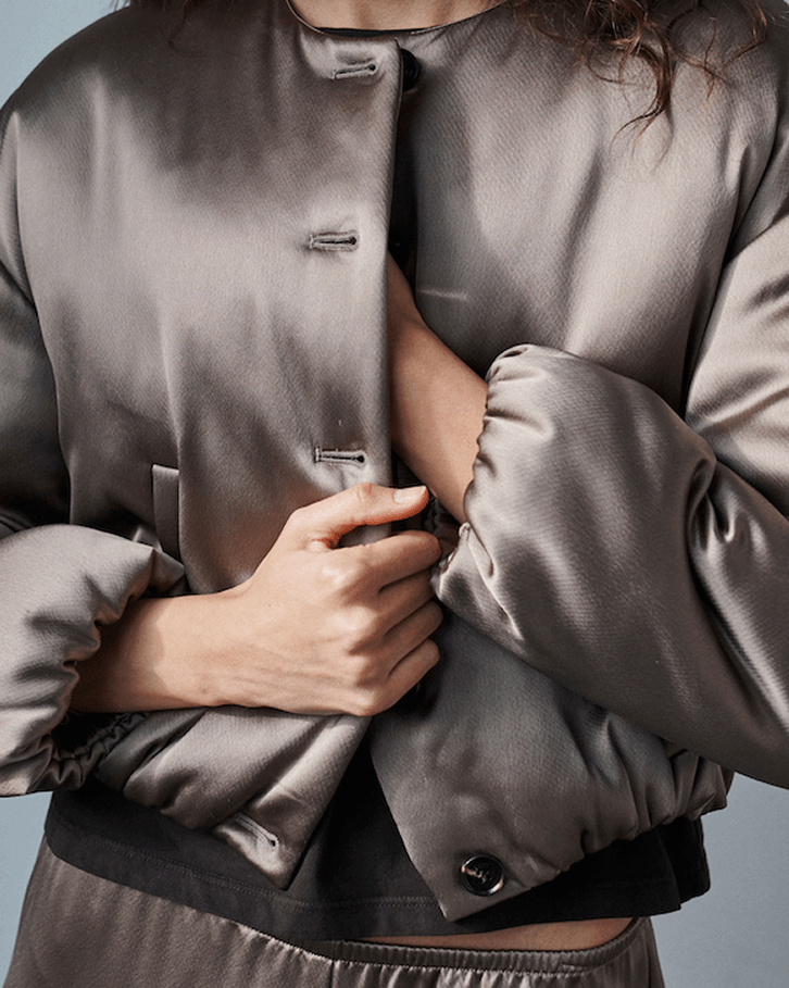 Close up of Barb bomber jacket with buttons.