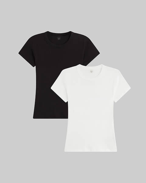 Woman wearing the white Margo t-shirt holding bag, with white skirt.