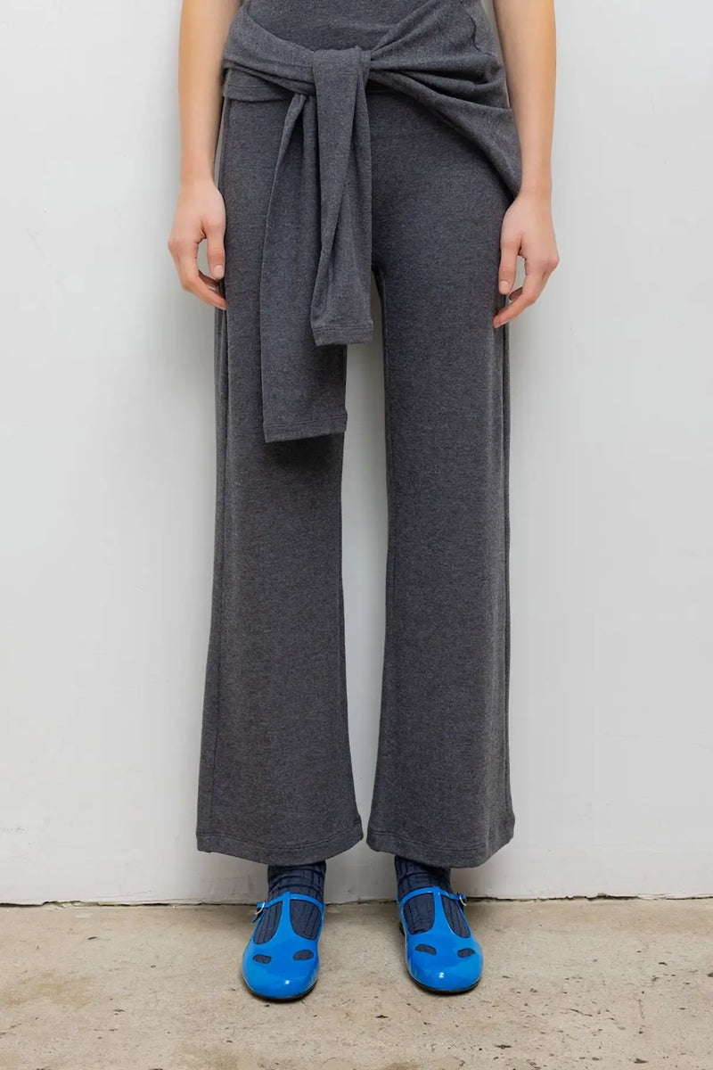 Close up of model wearing lauren crop flare pant in charcoal with blue mary janes.