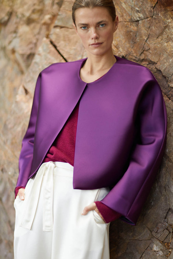 Woman in purple Bobbi coat over mulberry sweater and Barb satin pants