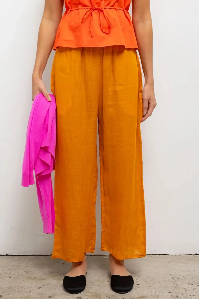 Close up of Niko crop drawstring pant on model in orange.